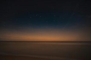 The big dipper shines over a vast landscape at twilight. Photo Credit: Marek Piwnicki | Pexels