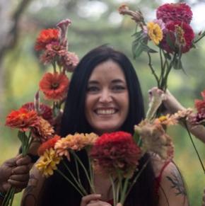 Picture of Briana Anderson surrounded by flowers
