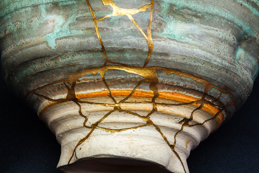 This piece of pottery, once broken, that has been repaired with the Kintsugi art form using lacquer and gold to fill in the cracks. Photo Credit: PhotoBeard